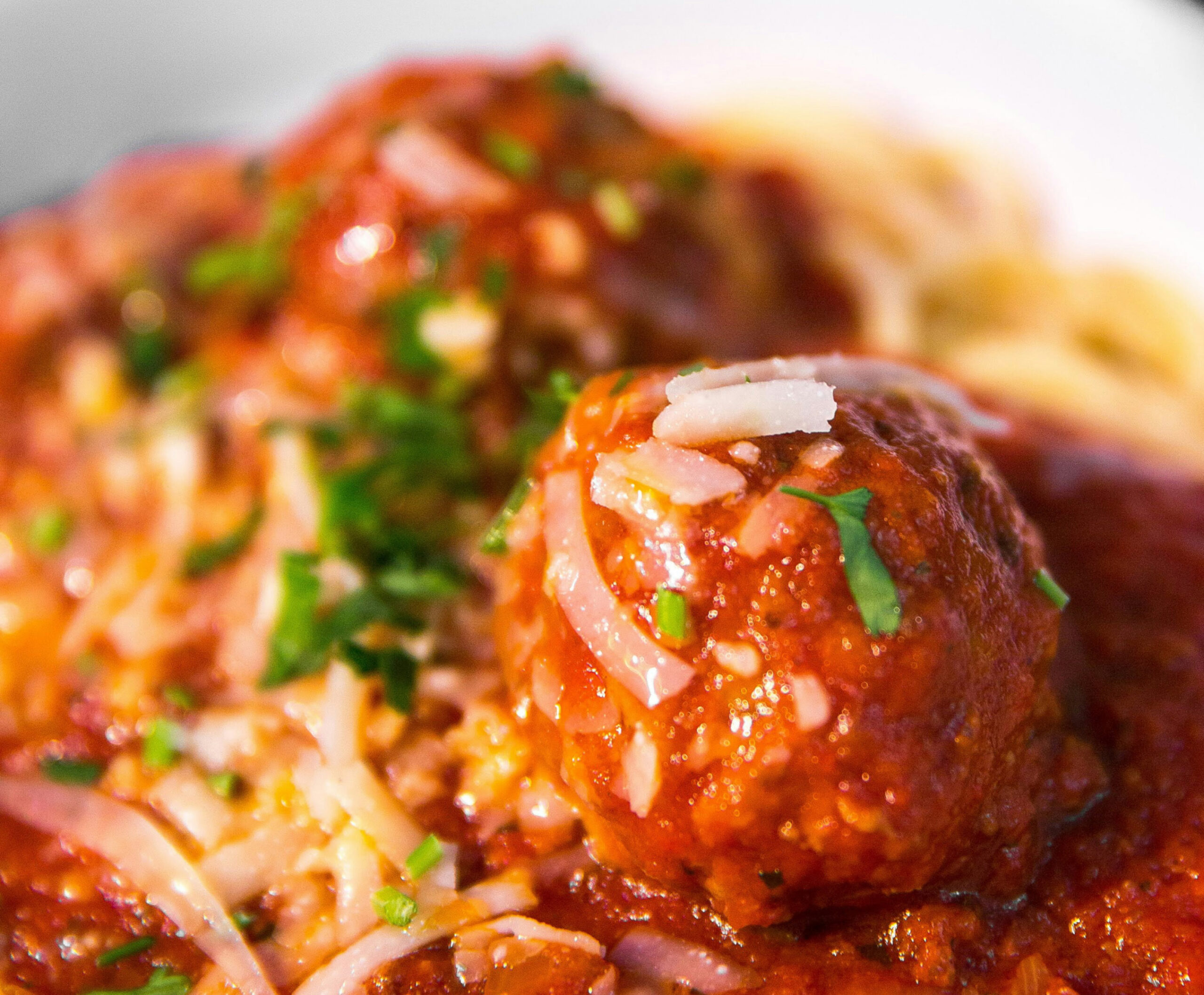 Close up of tomato sauce and meatball