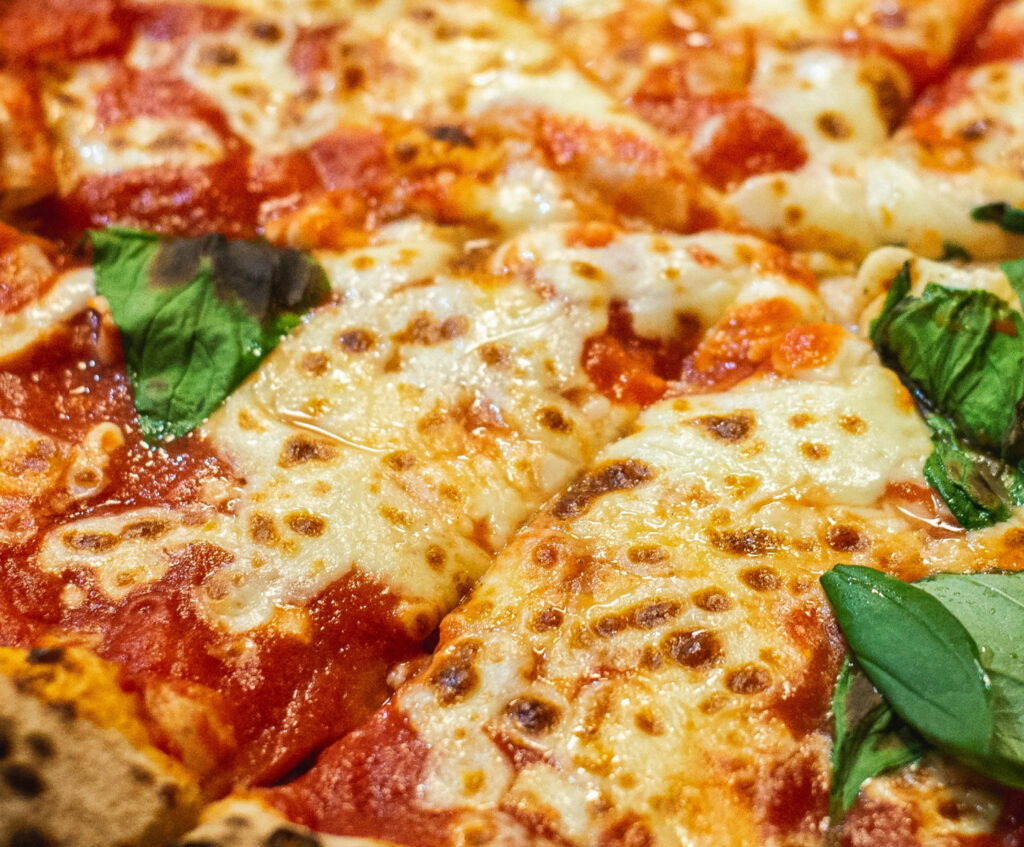 Close up of cheese pizza with basil