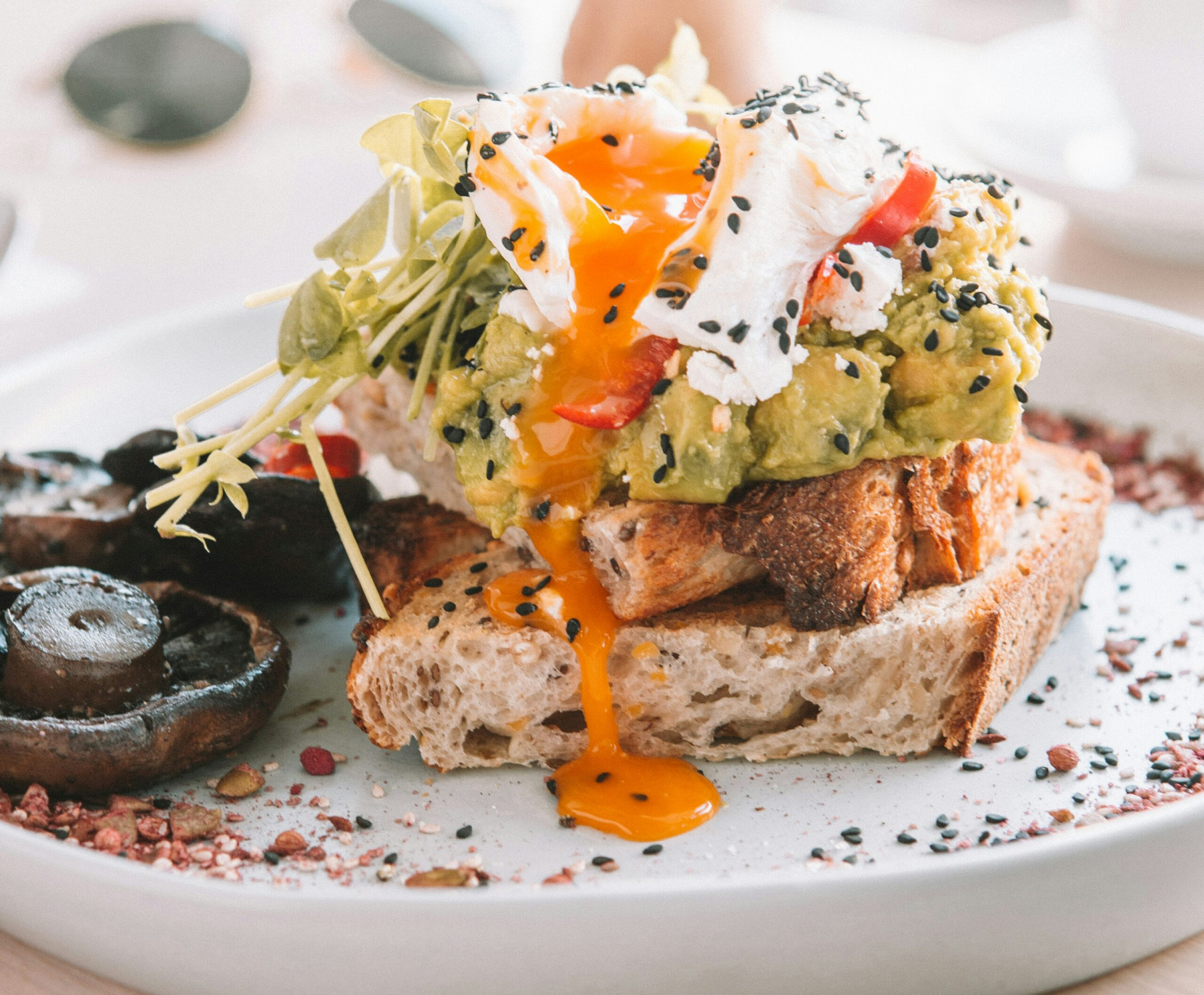 Close up of avocado toast with egg and black sesame seeds