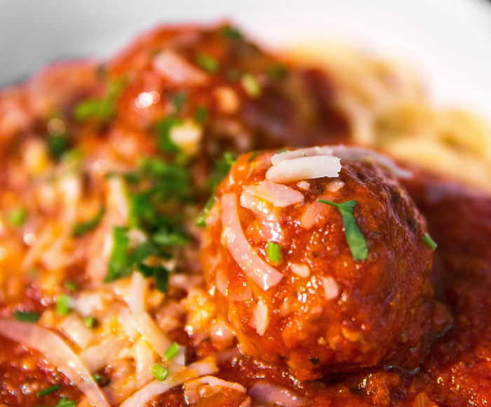 Close up of tomato sauce and meatball